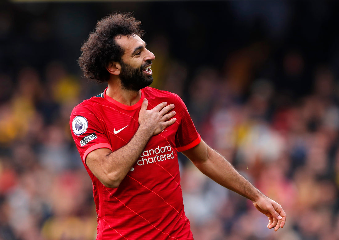 Mohamed Salah celebrating after scoring against Watford in a Premier League match to secure a 5-0 win for Liverpool
